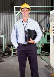 Auditor standing on a factory floor Auditor standing on a factory floor