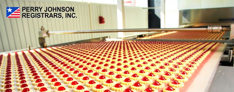 Mass production of a cherry dessert on a conveyor system with Perry Johnson Registrars, Inc. logo Mass production of a cherry dessert on a conveyor system with Perry Johnson Registrars, Inc. logo