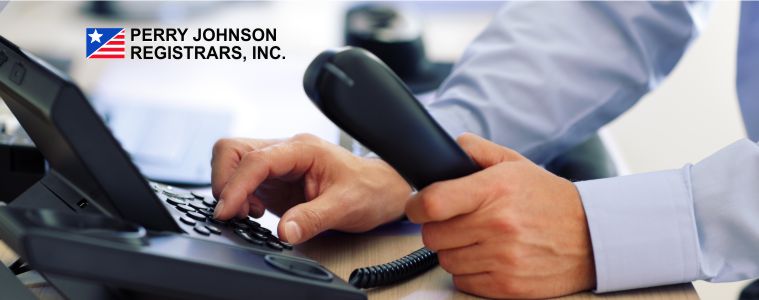 Person making a phone call with the Perry Johnson Registrars, Inc. logo