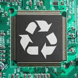 A recycling logo on a computer chip on a motherboard A recycling logo on a computer chip on a motherboard