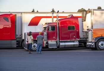 Semi drivers talking near parked trucks Semi drivers talking near parked trucks