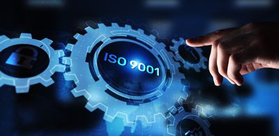 Hand pointing to ISO 9001 on gears
