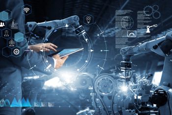 Man holding laptop running AI in a manufacturing setting Man holding laptop running AI in a manufacturing setting